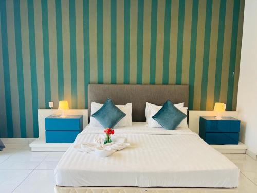 a bedroom with a large bed with blue and green walls at Platinum KLCC Suites Face in Kuala Lumpur