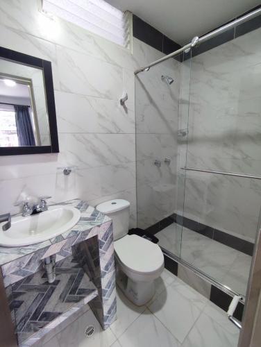 a bathroom with a toilet and a glass shower at Apartahotel JDK in Armenia