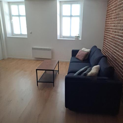 a living room with a couch and a coffee table at Green Corner of Bovec - Apartment Bovec in Bovec