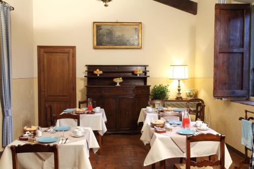 a dining room with tables and a piano at Rovezzano B&B in Florence
