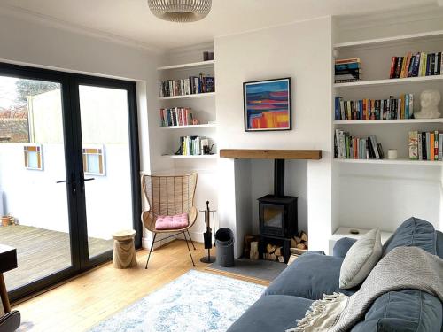 a living room with a couch and a fireplace at Stylish Home with 4 bedrooms, Logburner, Garden, nr Beach, Deal Castle in Deal