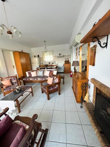 a large living room with couches and a fireplace at Panormitis House in Kefalos
