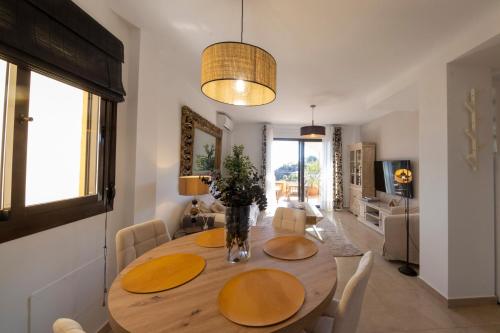 a dining room with a wooden table and chairs at Residencial Villa Marina CC1 in Águilas
