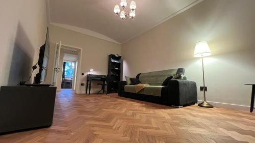 a living room with a couch and a piano at Cosy apartament in Buftea