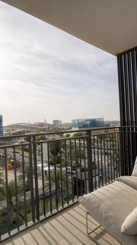 a bedroom with a balcony with a bed and a view at Noor Homes - Luxury Approved by the Department of Culture and Tourism, Abu Dhabi in Yas Island in Abu Dhabi