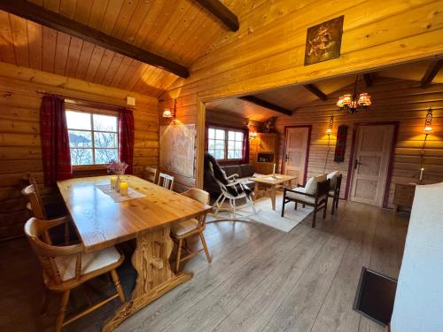 a dining room with a wooden table in a cabin at Aurora cabin Tromvik in Tromsø