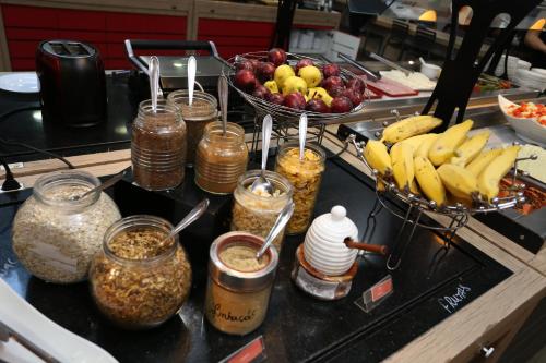 a counter with jars of food and a bowl of fruit at ibis Copacabana Posto 5 in Rio de Janeiro