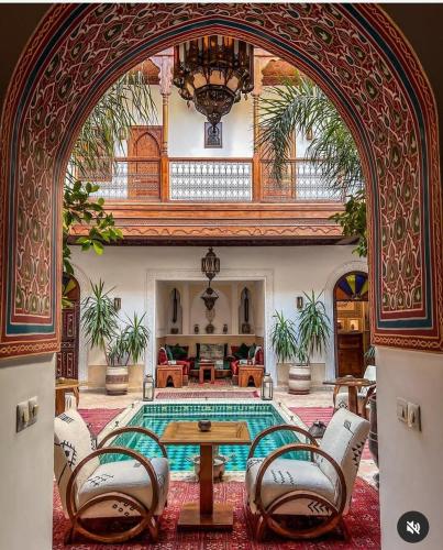 an archway in a room with a table and chairs at Riad Melhoun & Spa in Marrakech