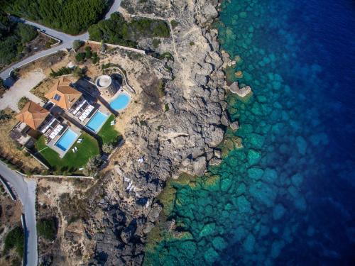 an aerial view of a house on a cliff near the water at Armonia Seaside Villas in Vasilikos