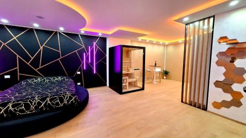 a bedroom with a bed and a purple wall at Torino d'Amare Suite in Turin