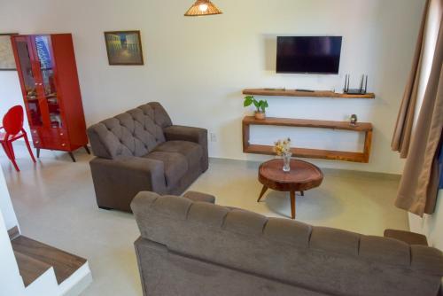 a living room with a couch and a table at Casa Portal do Pati in Lençóis