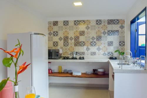 a kitchen with a refrigerator and a table in it at Casa Portal do Pati in Lençóis
