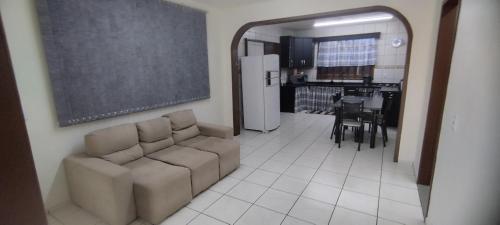 a living room with a couch and a black chalkboard at Casa Ponte Serrada in Joinville