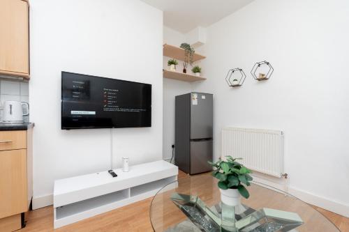 a living room with a tv on a wall at Elena Apartment in Southampton