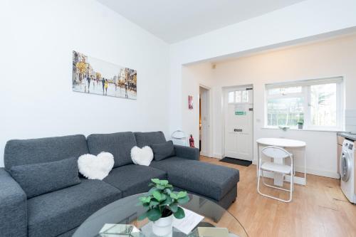 a living room with a couch and a table at Elena Apartment in Southampton