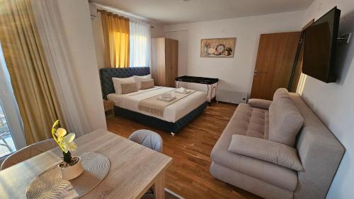 a hotel room with a bed and a living room at Soko City Center & Parking Free in Soko Banja