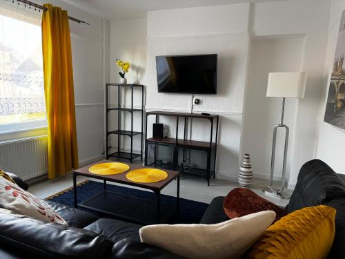 a living room with a couch and a coffee table at Peaceful & Convenient For business Trip & Families holiday & working proffesional-long term deals available , M1 J25-10Min , WI-Fi 500Mb , Netflix , Secure Huge Private garden with 6 cars parking space , Fully equiped kitchen , Few local shops near by in Nottingham