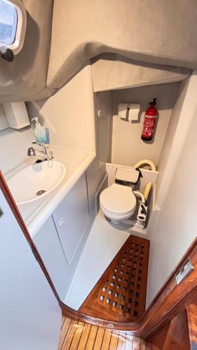 a small bathroom with a toilet and a sink at Slowlife in Lisbon