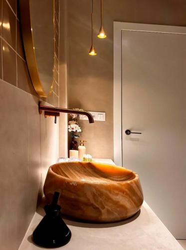 a wooden tub in a bathroom with a sink at Pivote Flats-Playa B in Valencia