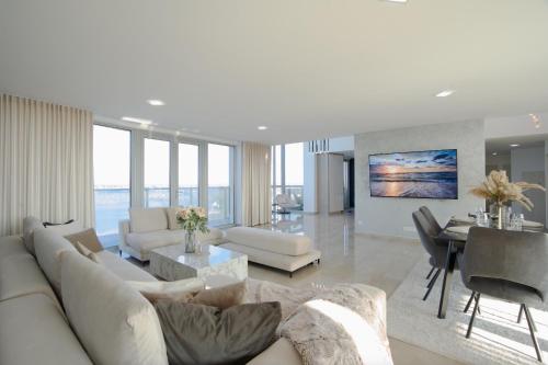 a living room with a white couch and a table at Luxusný Penthouse nad jazerami 230 m2, 2x garáž, WIFI in Senec