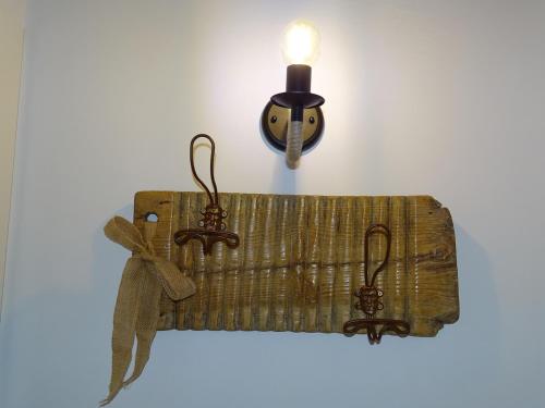 a wooden shelf with a candle on a wall at ALMA de la RIBERA in Peñafiel