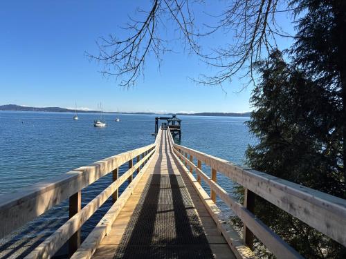 a wooden bridge over a body of water at Bayview Bed and Breakfast in Mill Bay