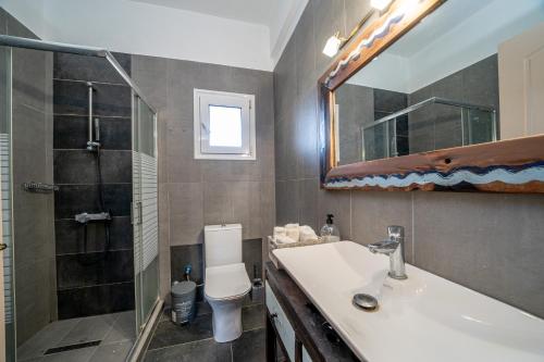 a bathroom with a sink and a shower and a toilet at Villa Sorina Kefalonia in Svoronata