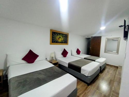Ένα ή περισσότερα κρεβάτια σε δωμάτιο στο Aguacatala Hotel Boutique