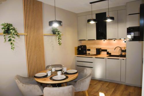 a kitchen with a table and chairs in a room at Sun View in Szklarska Poręba