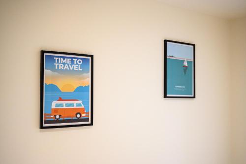 two framed posters hanging on a wall at Le 09-Appart'Hôtel-GregIMMO in Montbéliard