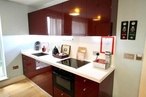 a kitchen with a sink and a counter top at Residences at The Gyle - London in London