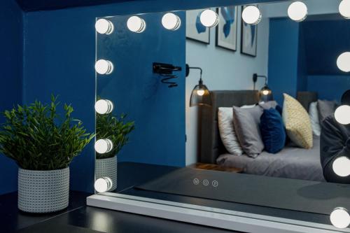 a room with a couch and a table with a mirror at Modern Cozy Retreat-Family-Friendly-Near City & Peak District in Sheffield