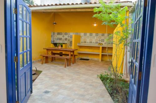 a patio with a wooden table and a bench at Casa Portal do Pati in Lençóis