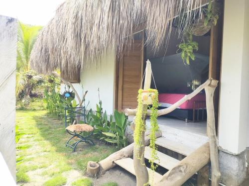 a room with a bed and a hammock outside of a house at la casablanca moñitos in Moñitos