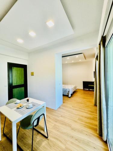 a living room with a table and a bed at VALE MAR Guest in Ribeira Brava
