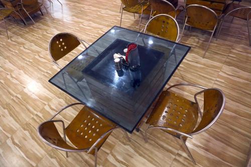 a table with a person sitting on top of it at AamraKunj Gir Resort in Sasan Gir