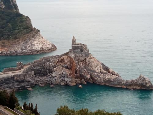 an island in the water with a castle on it at La Terrazza sul Mare in Levanto