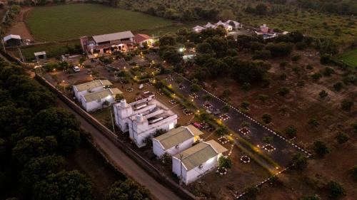 an aerial view of a house with a parking lot at AamraKunj Gir Resort in Sasan Gir