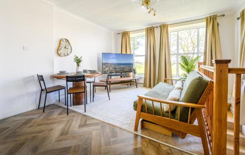 a living room with a table and a dining room at Oxendon Oasis- Luxury Hot Tub Retreat in Market Harborough
