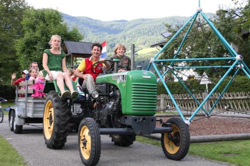 a group of people riding on a tractor at Alpencamp Kärnten in Kötschach