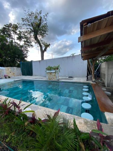 a swimming pool with chairs in a backyard at Oasis by Franklin Hotel Boutique in Fortuna