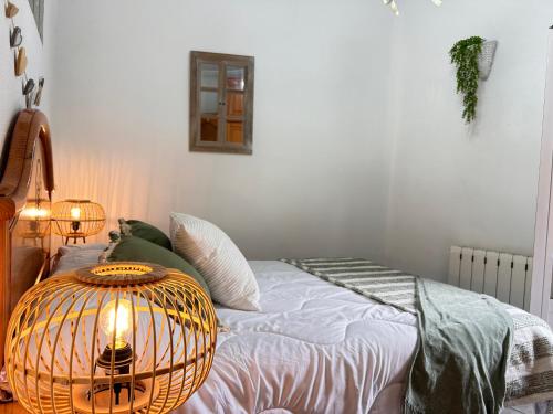 a bedroom with a bed with a bird cage on it at Apartamento La Plaza! in Bogarra