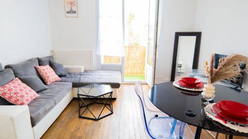 a living room with a couch and a table at Charming T2 Cozy close to Orly airport in Athis-Mons