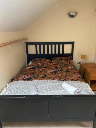 a bed with two pillows on it in a bedroom at Oriel House in Great Malvern