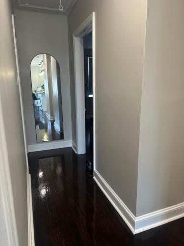 a living room with a mirror and a hallway at Home in North Wilmington in Wilmington
