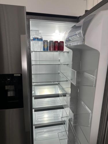 an empty refrigerator with its door open with water bottles at Home in North Wilmington in Wilmington