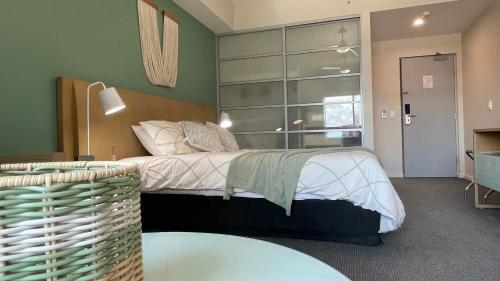 a bedroom with a bed with a large window at Deluxe studio at Mantra in Darwin