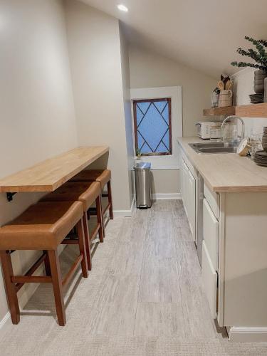 a kitchen with a counter and a table with stools at Guesthouse on Girod in Mandeville