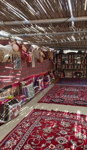 a room with lots of carpets on the floor at zahr albun villa in Al Raka