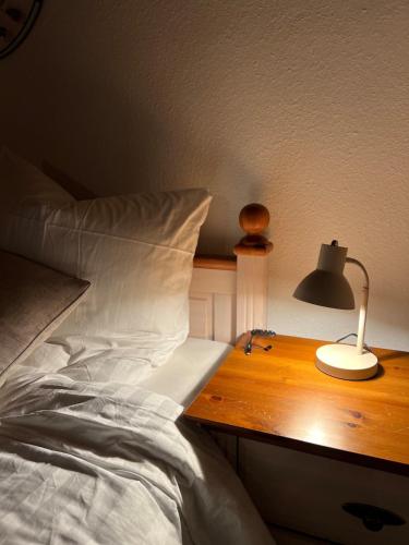 a bed with a desk with a lamp on it at Minimalist Cozy Apartment near Frankfurt in Altenstadt